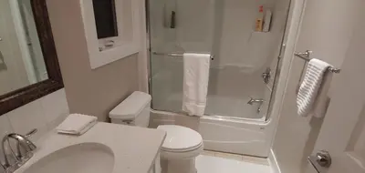 a bathroom with a shower and a toilet and a sink at Burnaby 4 bed 3 bath duplex in Burnaby