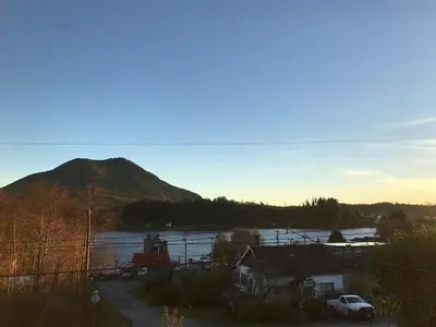 a view of a body of water with a mountain at Coastal Suite - Harbourview in Ucluelet in Ucluelet