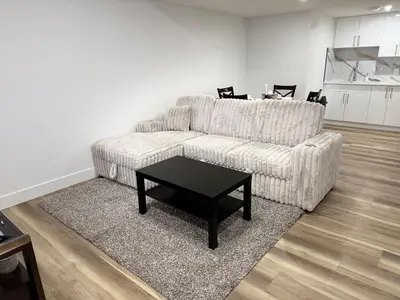 a living room with a couch and a coffee table at Charming Basement Suite in Edmonton