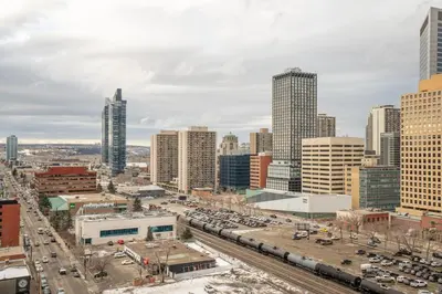 a view of a city with buildings and traffic at Stylish Condo with Exclusive Rooftop Pool in Calgary