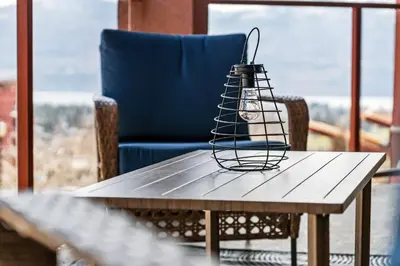 a table with a lamp on top of it at Luxury Lake View Condo in West Kelowna, 5 Star Resort with Pool, Hot Tub and Gym in West Kelowna