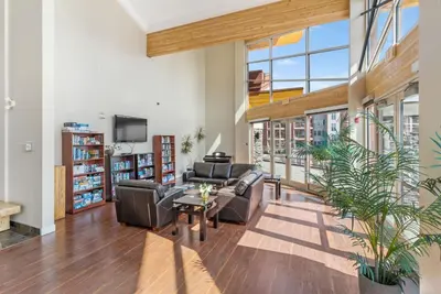 a living room with a couch and a table at Luxury Lake View Condo in West Kelowna, 5 Star Resort with Pool, Hot Tub and Gym in West Kelowna