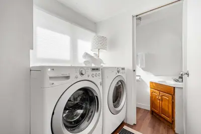a white laundry room with a washer and dryer at Bluebird 3 Bedroom Home in the Heart of Drumheller in Drumheller