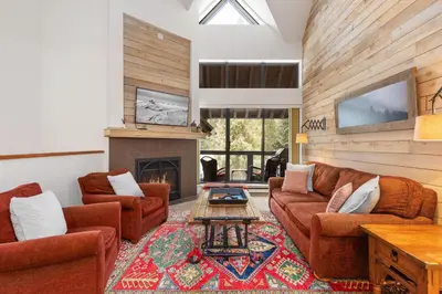 a living room with two couches and a fireplace at Foxglove by Whistler Premier in Whistler