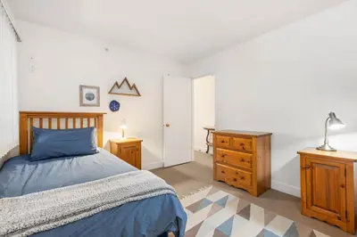 a bedroom with a bed and a dresser and a desk at Foxglove by Whistler Premier in Whistler