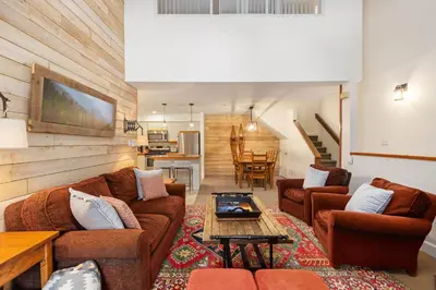 a living room with couches and a table at Foxglove by Whistler Premier in Whistler