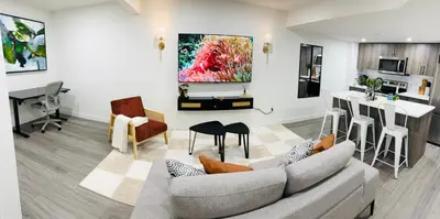 a living room with a couch and a table at Coziest & Modern Basement Retreat East of Calgary in Chestermere