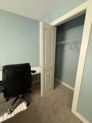 a room with a desk and a chair next to a door at 2 bedroom Suite with private entrance in Langley
