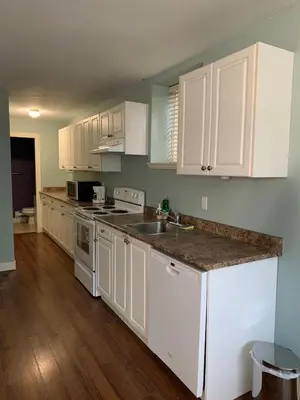a kitchen with white cabinets and a counter top at 2 bedroom Suite with private entrance in Langley