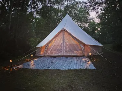 a tent sitting on top of a blanket in the grass at Everlong Acres Belle Tent in Owlseye