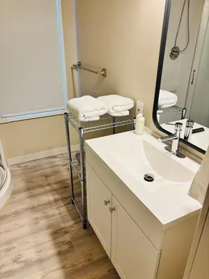 a bathroom with a sink and a mirror at Upper Floor 1 Bedroom Suite with Parking in Calgary
