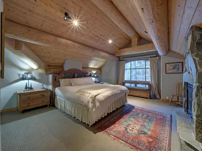 a bedroom with a bed and a wooden ceiling at Hapala Chalet in Whistler
