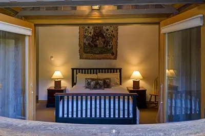 a bedroom with a large bed with two lamps at Hapala Chalet in Whistler