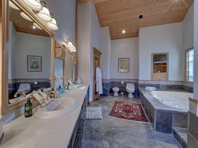a large bathroom with two sinks and a tub at Hapala Chalet in Whistler