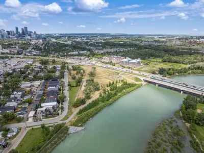 an aerial view of a city with a bridge over a river at Modern 3 Bedroom Suite Near Downtown & Stampede Grounds in Calgary