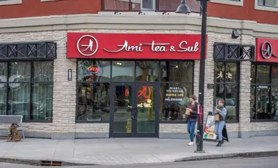 a store with a red sign on the side of a street at Modern 3 Bedroom Suite Near Downtown & Stampede Grounds in Calgary