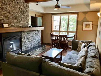 a living room with a couch and a fireplace at Mountain View Retreat in Radium Hot Springs