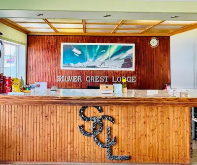a sign for a silver crest lodge is on a counter at Silver crest lodge in Grande Prairie