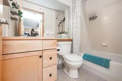 a bathroom with a toilet and a tub and a sink at Rocky Mountain Oasis-Mountain View! in Canmore