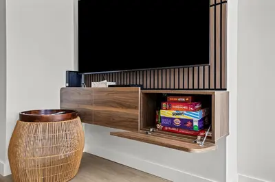 a entertainment center with a tv on a wall at 2BR 2BA Harvie Heights Townhouse retreat with views in Canmore