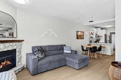 a living room with a couch and a fireplace at 2BR 2BA Harvie Heights Townhouse retreat with views in Canmore