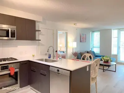 a kitchen with a sink and a living room at Comfort in Richmond center 2bedr & good location in Richmond