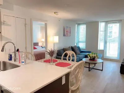 a kitchen and living room with a blue couch at Comfort in Richmond center 2bedr & good location in Richmond