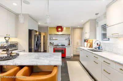 a kitchen with white cabinets and a red stove top oven at Couple's Oasis at Horner Park in Victoria