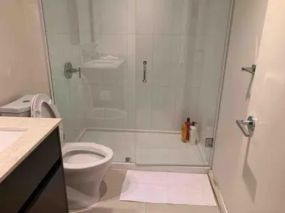 a bathroom with a shower and a toilet at Amazing brand new 2bedr&2bathr in Richmond center in Richmond
