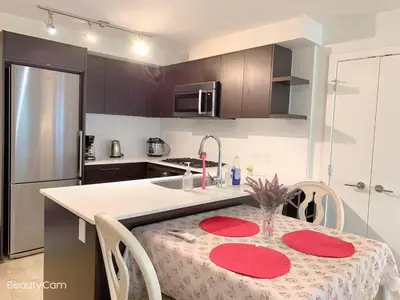 a kitchen with a table with red plates on it at Amazing brand new 2bedr&2bathr in Richmond center in Richmond