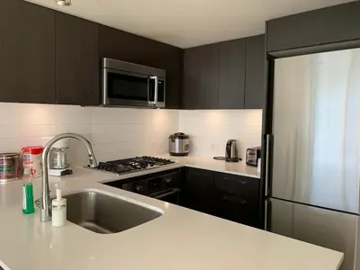 a kitchen with a stainless steel refrigerator and a sink at Amazing brand new 2bedr&2bathr in Richmond center in Richmond