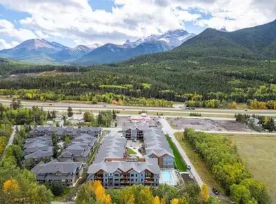 an aerial view of a resort with mountains in the background at Sparrowhawk Mountain Resort in Dead Man's Flats