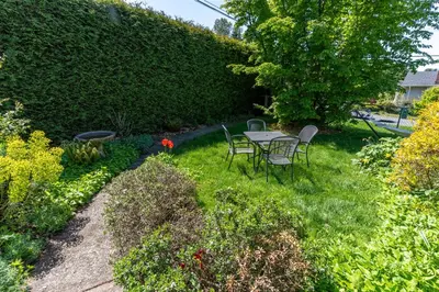 a garden with a table and chairs in the grass at Family Cottage at Horner Park in Victoria