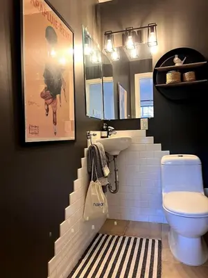 a bathroom with a staircase with a sink and a toilet at Family Cottage at Horner Park in Victoria