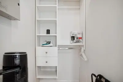 a kitchen with white cabinets and a refrigerator at Bright and Comfy 3BR Home Ideal for Families in Vancouver
