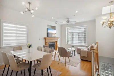 a dining room with a table and chairs and a fireplace at Bright and Comfy 3BR Home Ideal for Families in Vancouver
