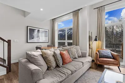 a living room with a couch and windows at Township by Canmore Premier in Canmore