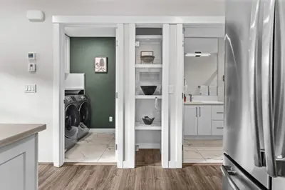 a kitchen with a refrigerator and a washer and dryer at Township by Canmore Premier in Canmore