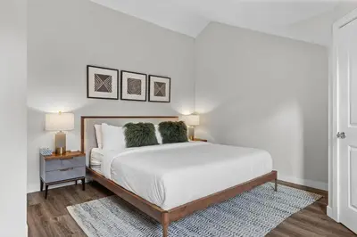a white bedroom with a large bed with two pillows at Township by Canmore Premier in Canmore