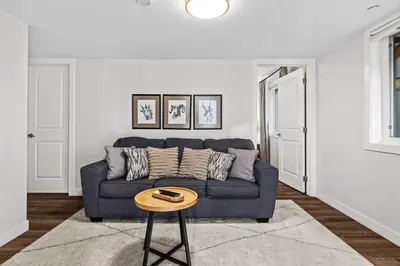 a living room with a blue couch and a table at Township by Canmore Premier in Canmore