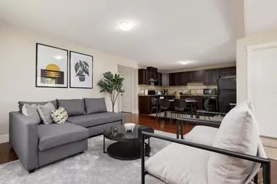 a living room with a couch and a kitchen at Peaceful spacious 2BR Suite in Nanaimo