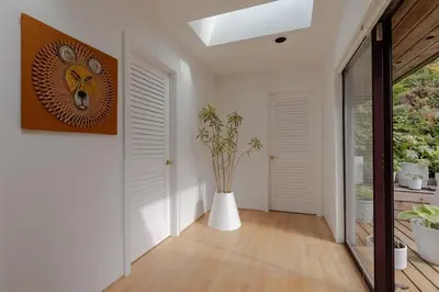 a hallway with a vase with a plant in it at The Cougar Den in Tofino