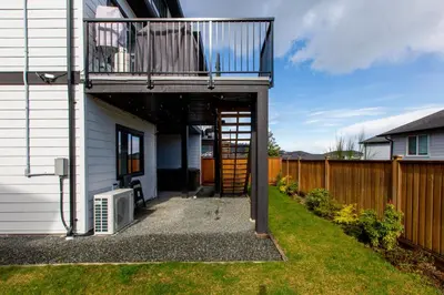 a balcony on the side of a house at Cozy Garden Suite with Hot Tub and Perfectly Located in Goldstream Station