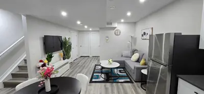 a living room with a couch and a table at Bleniel Place - Stylish Basement Suite with Wi-Fi Netflix & Parking in Edmonton