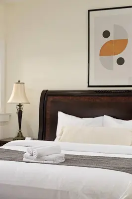 a bedroom with a bed with towels on it at Charming Luxury Home near DT and Lonsdale Quay in North Vancouver