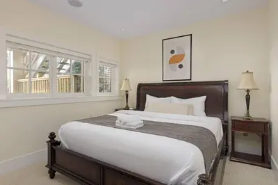 a bedroom with a large bed and a window at Charming Luxury Home near DT and Lonsdale Quay in North Vancouver