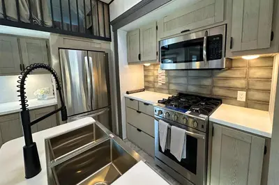 a kitchen with a stainless steel stove and microwave at Fernie RV Resort in Fernie