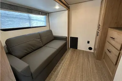 a couch in a small room with a window at Fernie RV Resort in Fernie