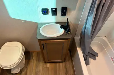 a small bathroom with a toilet and a sink at Fernie RV Resort in Fernie
