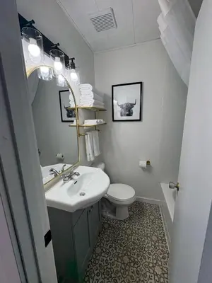 a white bathroom with a sink and a toilet at Remo Stays in Unity